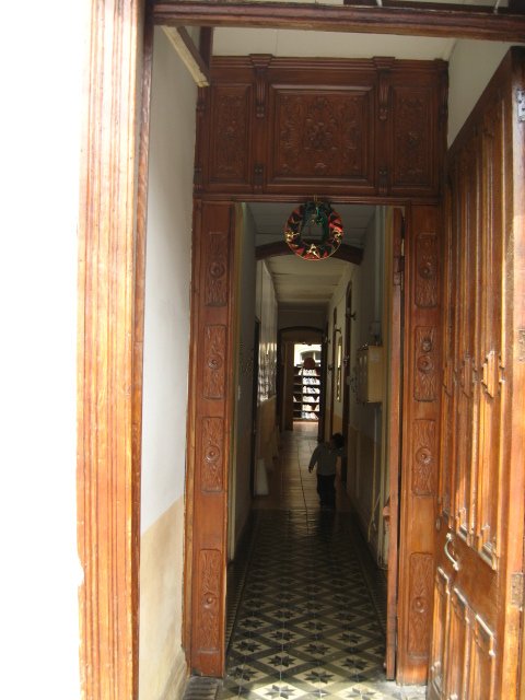 Public library.  Camera is at street looking in; there are rooms of books, and the main collection under a central roof of glass.
